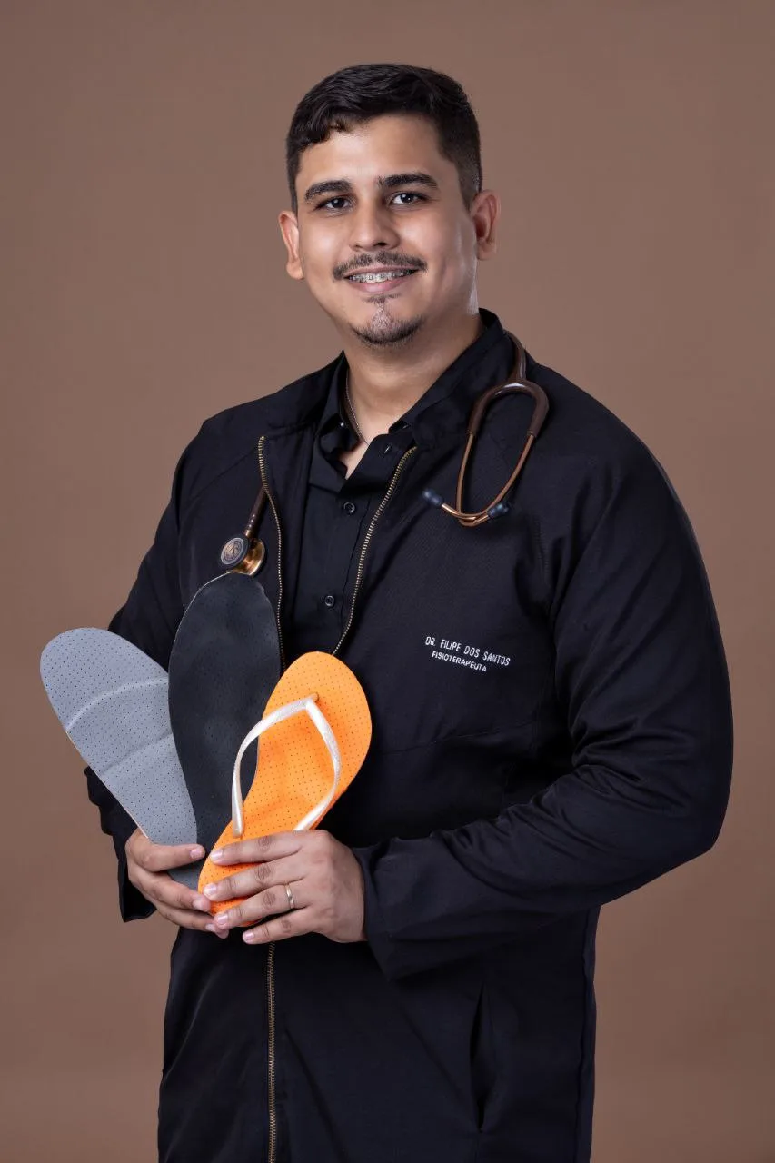 Dr. Filipe segurando palmilhas terapêuticas